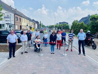 Bürgermeisterin Ulrike Westkamp zusammen mit Vertreter*innen der Ratsfraktionen sowie Büdericher Vereine auf der Weseler Straße in Büderich